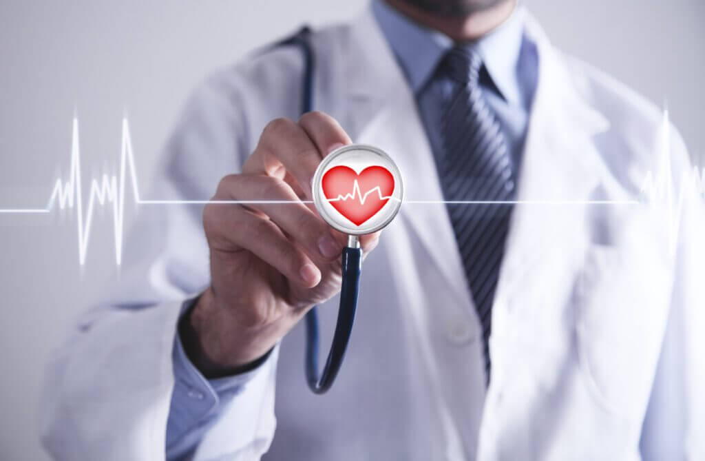 Doctor with stethoscope holding red heart